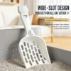 cat-litter-scoop-38-1 wide slot plastic cat litter scoop with cat head handle placed in cat litter box to show multi gap hole design for all litter types